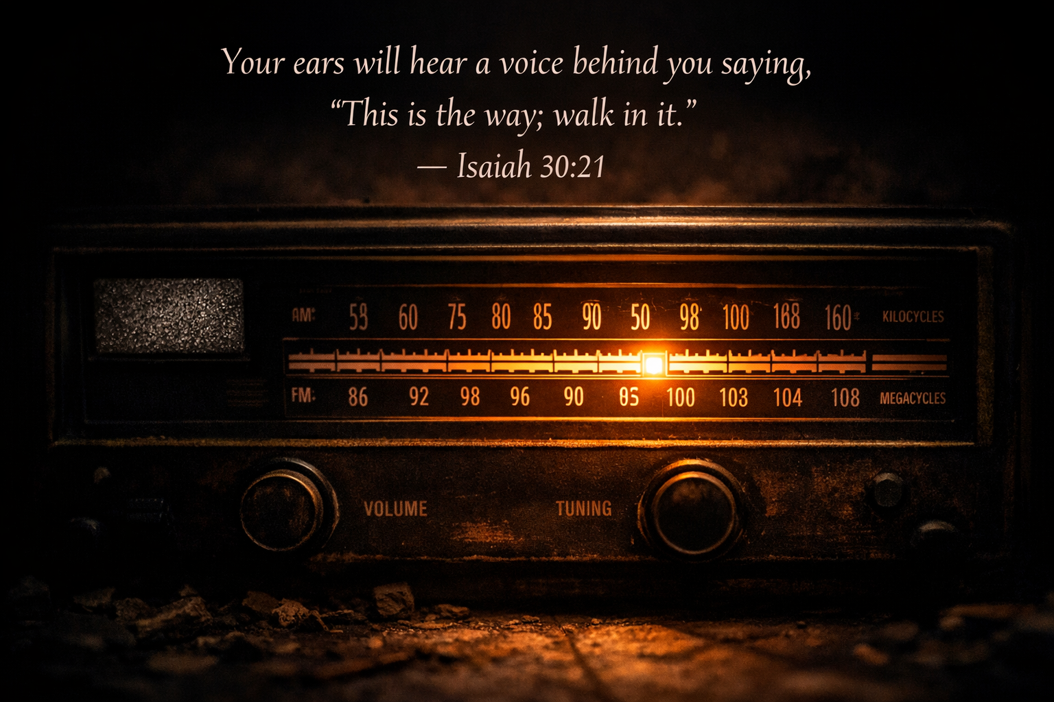 Old radio dial with one frequency glowing warm in dark room — Isaiah 30:21 hear a voice Bible verse wallpaper